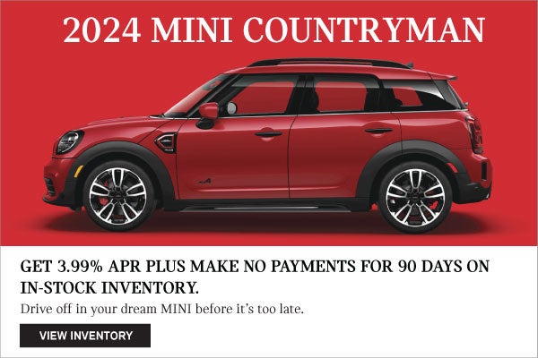 Full left view of red MINI Countryman with a red background.