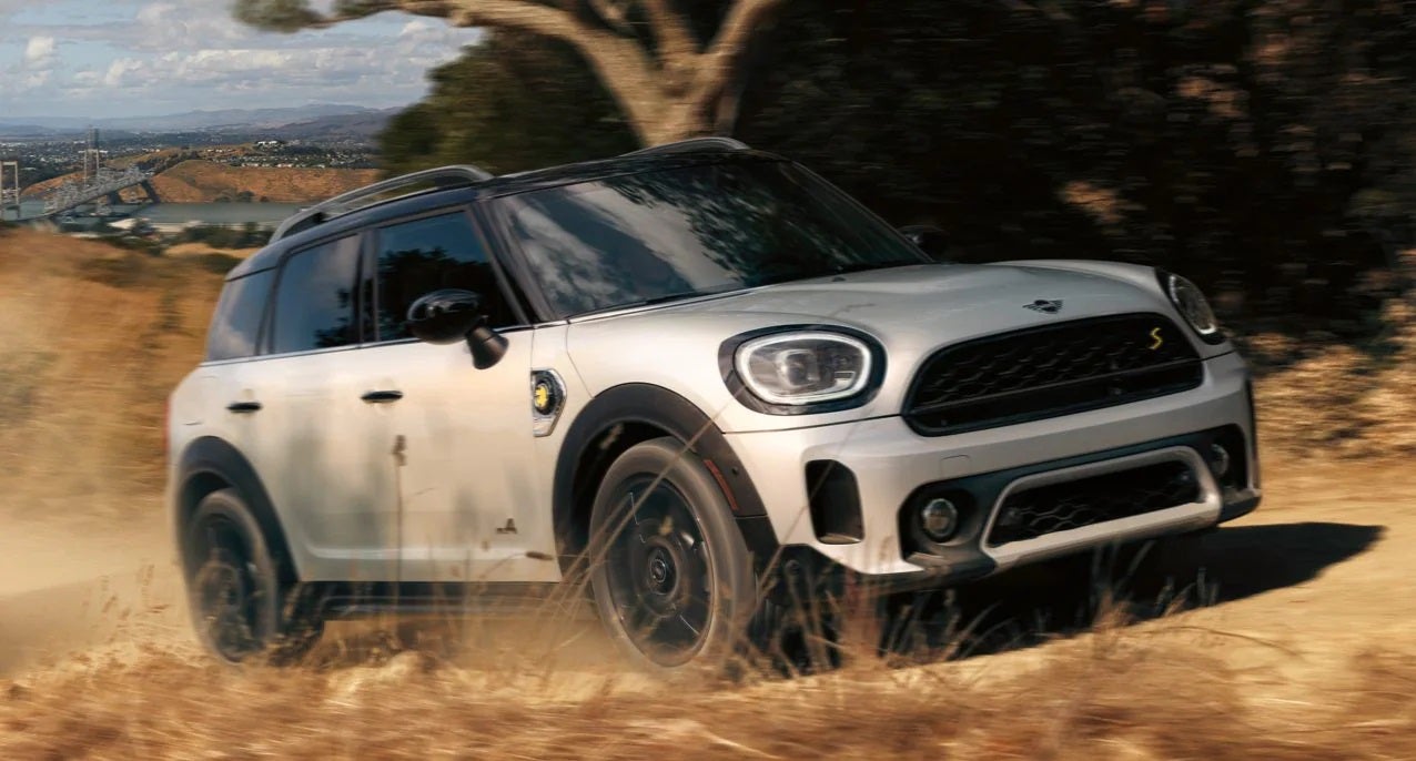 The MINI Cooper SE Countryman PHEV driving on dirt terrain. Tom Bush MINI in Jacksonville FL