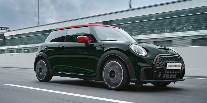 A MINI Certified Pre-Owned Cooper cruising on a racetrack.