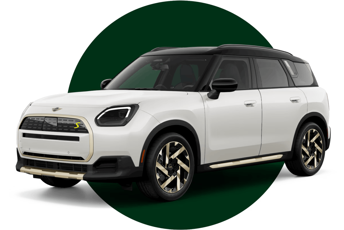 Angled view of a white MINI Countryman SE ALL4 vehicle parked in front of a green circle with a blue background.