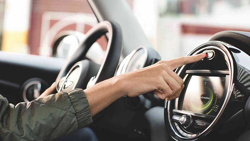 A hand interacting with the MINI Display.